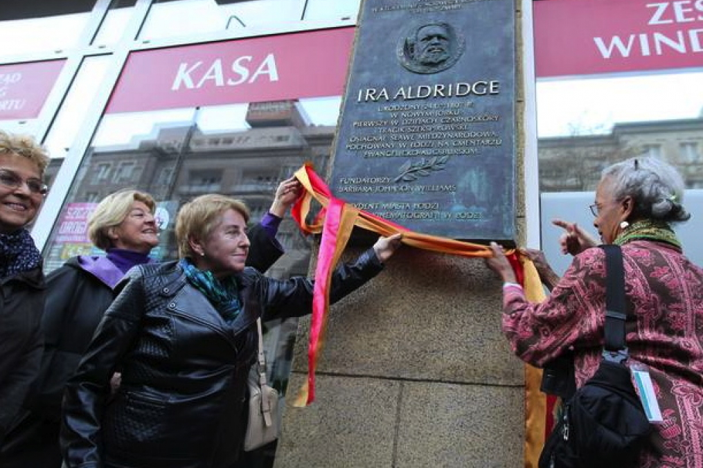 Barbara Johnson Williams helps hang a plaque