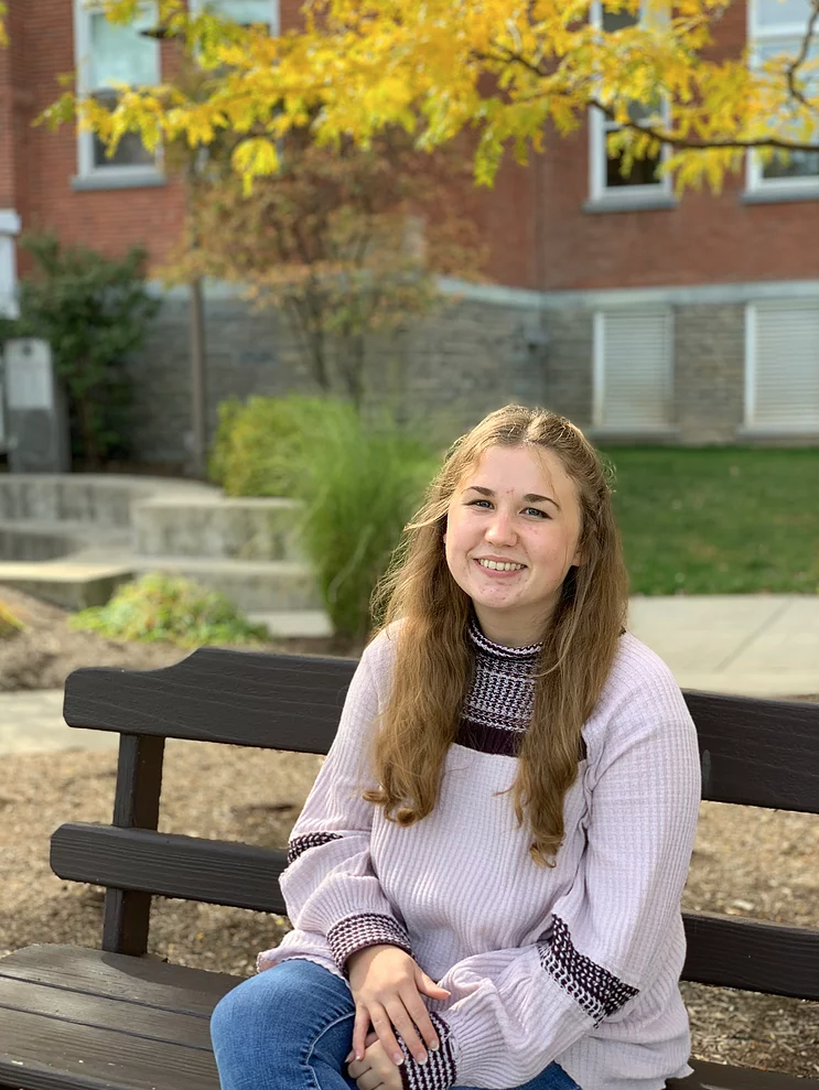 Madalyn Robbins sitting on a bench 
