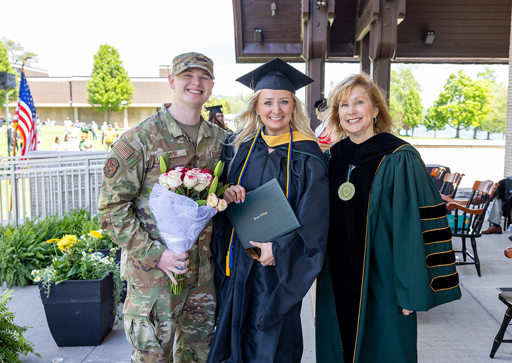 Elizabeth Stewart posing with military brother and Keuka College president
